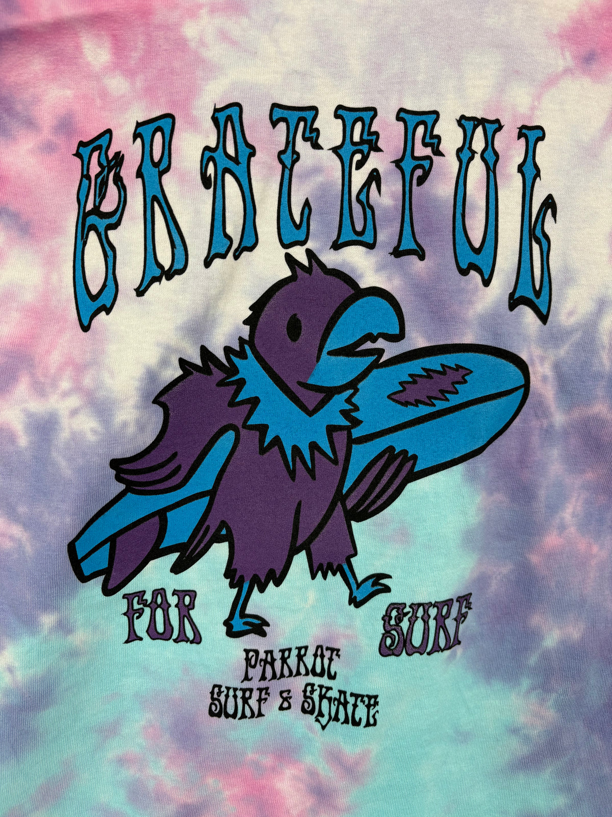 Youth wearing Parrot Surf Shop Grateful for Surf tie-dye T-shirt in cotton candy color