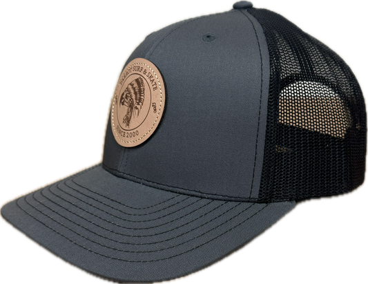 Parrot Surf & Skate 112 Indian Trucker hat in Charcoal/Black with leather Indian patch, side view - Parrot gear