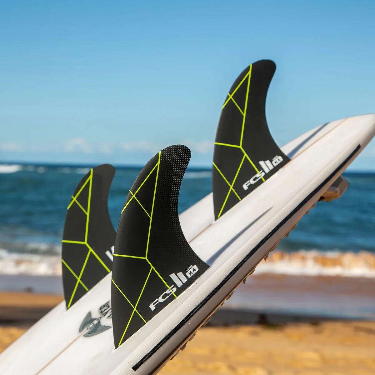 FCS II Kolohe Andino PC Tri Fin Set installed on surfboard view