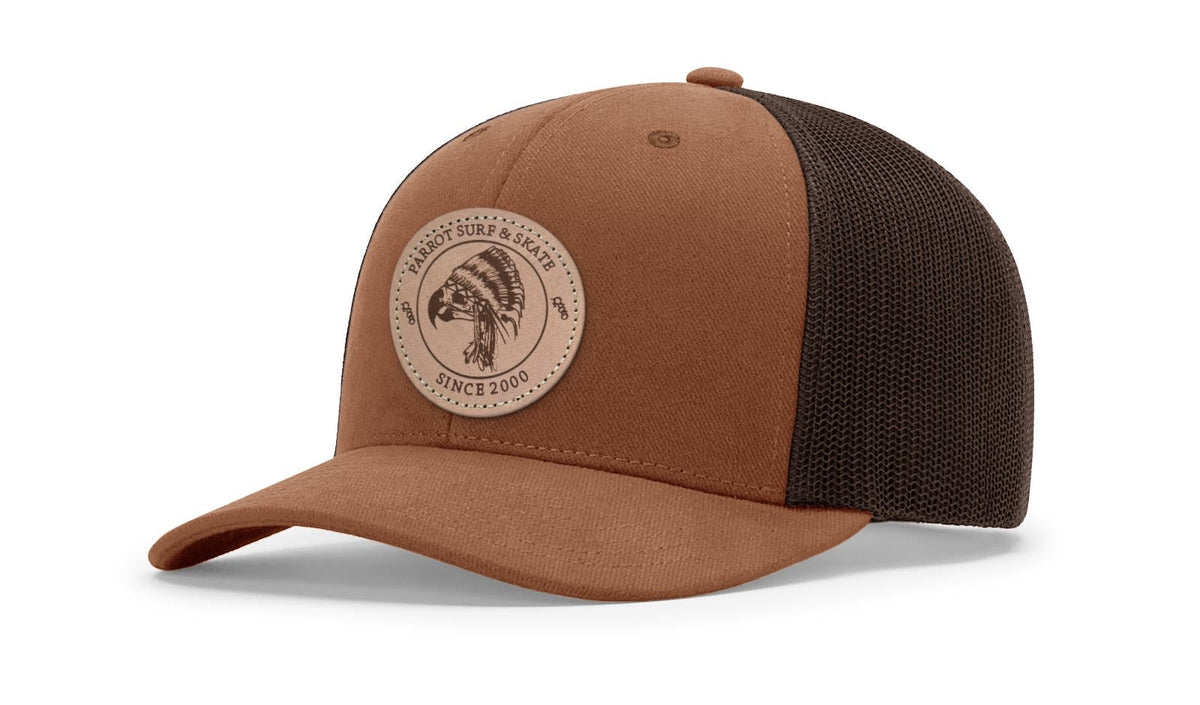 Parrot Surf & Skate 112LN Indian Trucker hat in Autumn/Brown with leather Indian patch, studio angle view - Parrot gear