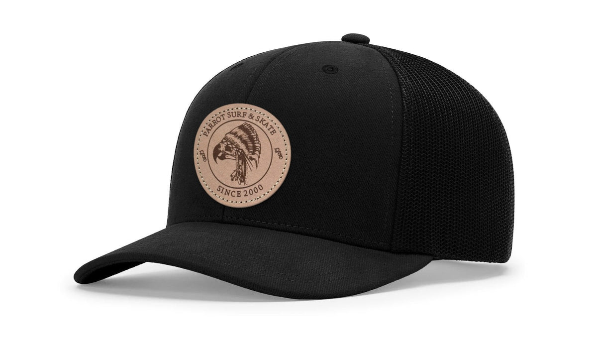Parrot Surf & Skate 112LN Indian Trucker hat in Black with leather Indian patch, studio angle view - Parrot gear