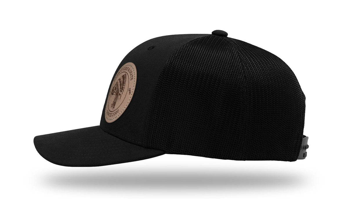 Parrot Surf & Skate 112LN Indian Trucker hat in Black with leather Indian patch, side profile view - Parrot gear