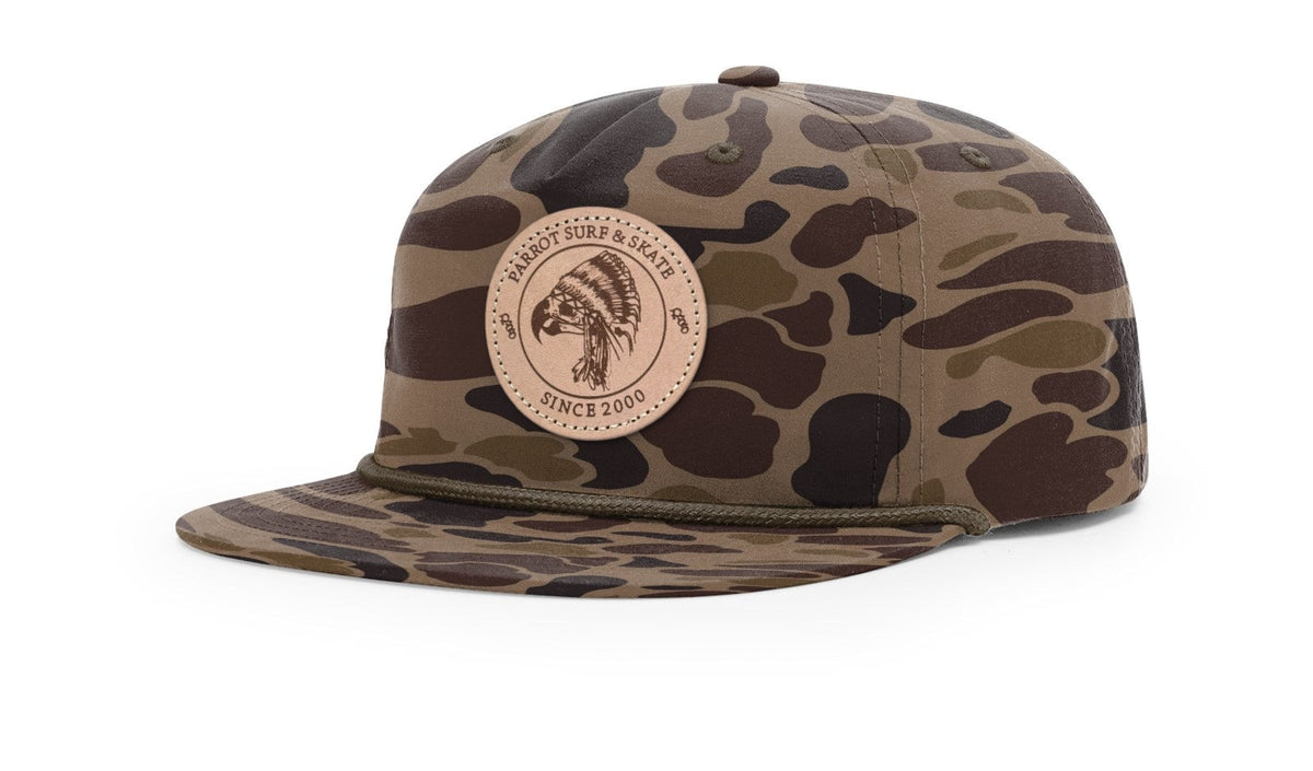 Parrot Surf & Skate 256P Indian Rope hat in Bark Duck Camo with brown rope and leather Indian patch, studio angle view - Parrot gear