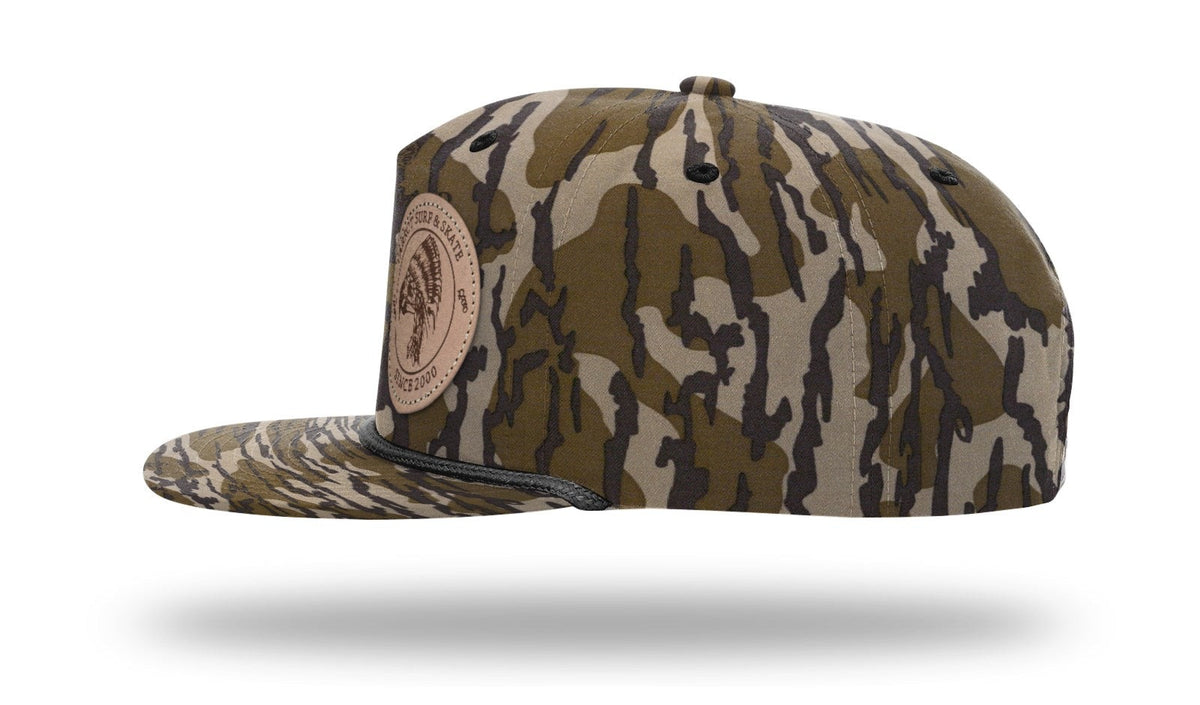 Parrot Surf & Skate 256P Indian Rope hat in Mossy Oak Bottomland with black rope with leather Indian patch, side profile view - Parrot gear