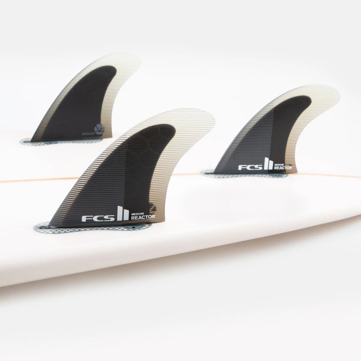 FCS II Reactor PC Tri Fin Set installed on surfboard view