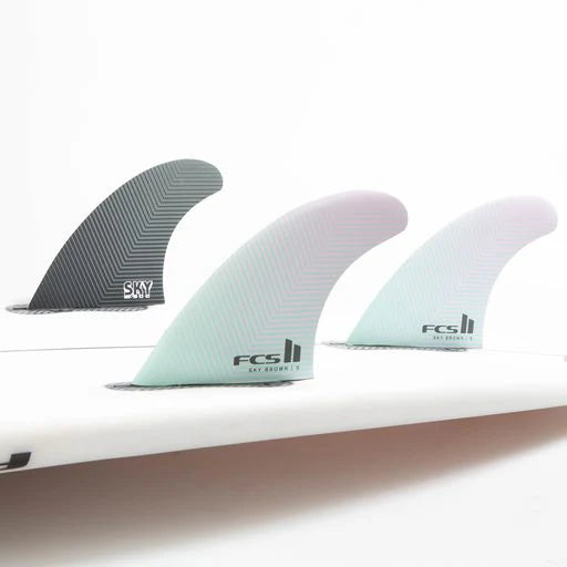 FCS II Sky Brown PC Tri Fin Set installed on surfboard view