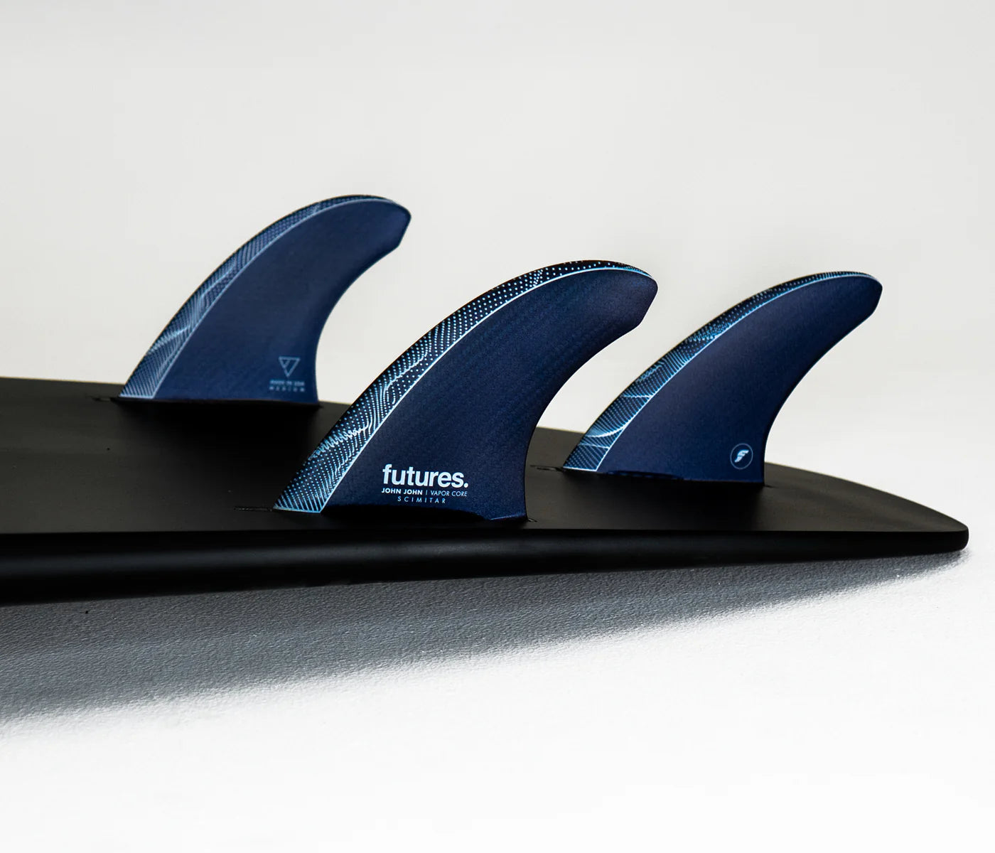 JJF Scimitar Vapor Core M Futures Fins installed on surfboard view